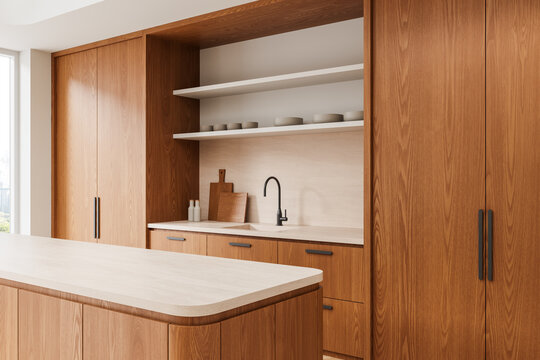 Modern warm wood kitchen interior with minimalist cabinets, open shelves, light countertops, and contemporary fixtures in a serene setting. 3D Rendering