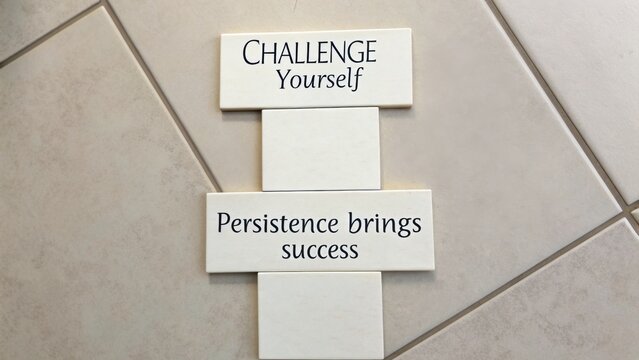 Inspirational message on tiles encouraging personal growth and determination through persistence and self-challenge, motivational quote
