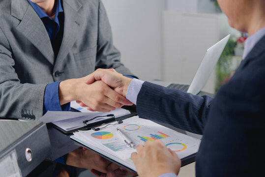 Businessmen shaking hands financial partnership success corporate deal investment agreement cooperation finalizing merger contract over charts for banking commercial finance marketing banner