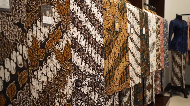 Various Traditional Indonesian Batik Fabrics with Intricate Patterns Displayed in a Local Boutique
