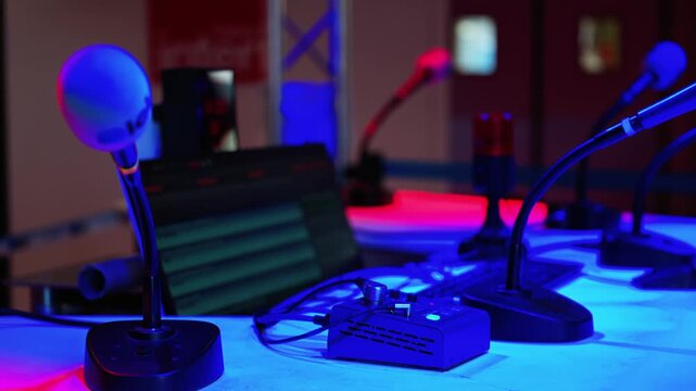 Professional radio podcast studio setup with microphones and sound equipment on table.