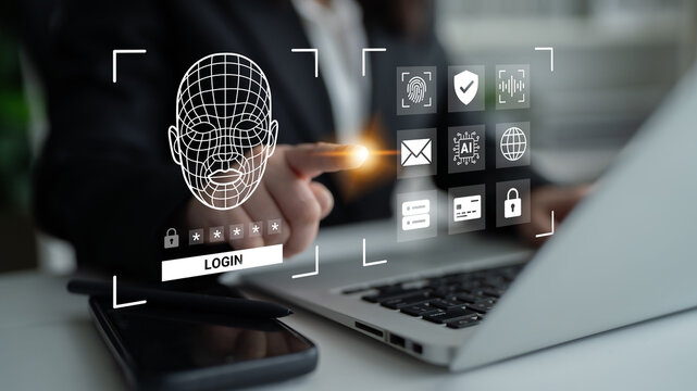 A businessman interacts with a facial recognition login interface on his laptop, showcasing modern technology in a contemporary office environment, emphasizing security and innovation. Ledger