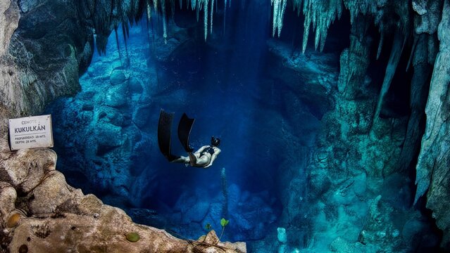 Freediver Exploring the Crystal Blue Waters of Cenote Kukulkan in Mexico