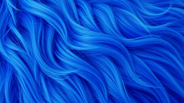 Close-up of wavy, vibrant blue synthetic fur or hair strands, creating a flowing, textured pattern with deep shadows and bright highlights