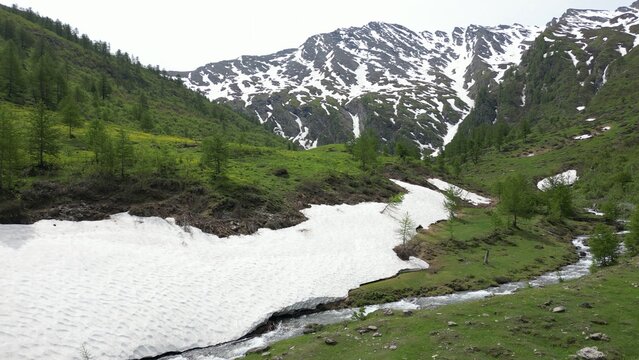 Europe, Italy, Alpeggio Balma di Rodoretto , Prali , Turin is a small mountain village with a stream of water due to the melting of the glacier ice - climate change and global warming save the planet