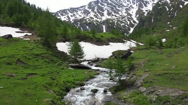 Europe, Italy, Alpeggio Balma di Rodoretto , Prali , Turin is a small mountain village with a stream of water due to the melting of the glacier ice - climate change and global warming save the planet