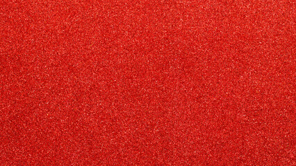 Fototapeta premium Sparkling red glitter texture background with shimmer effect for festive celebration