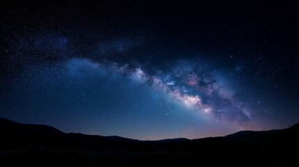 Obraz premium Milky way arc over dark silhouetted landscape for night wallpaper