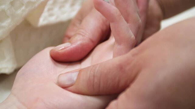 SPA salon. Massage room. A massage therapist is working with a young woman. Hand massage.
