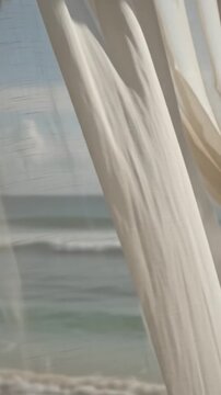 Dreamy shot of sheer curtains gently moving in the breeze inside a luxurious beach cabana with ocean waves visible, tropical opulence and calm.