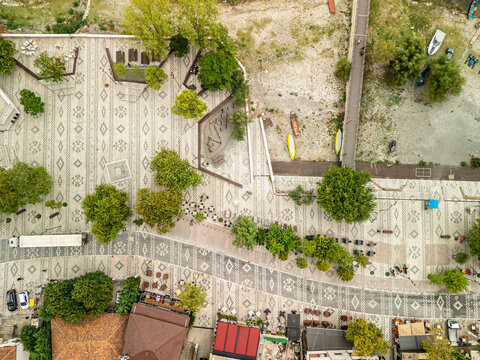 Albania, Shiroka 03 09 2025: Top down 90-degree drone shot of Shiroka promenade and street, showing contrasting color carpet patterns differentiating pedestrian areas from roadway.