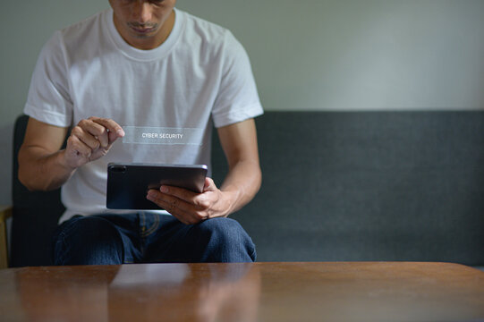 Person Using Tablet with Hologram for Cyber Security Concept