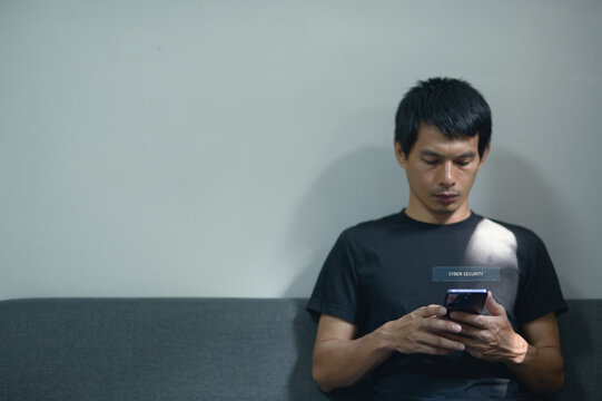 Man Engaged with Smartphone in Modern Indoor Setting with Hologram Theme