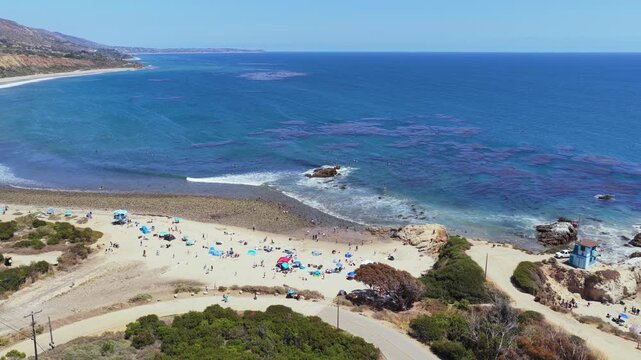 Leo Carrillo State Beach in Malibu showcasing California coastline with people enjoying sandy shore and turquoise Pacific Ocean water
