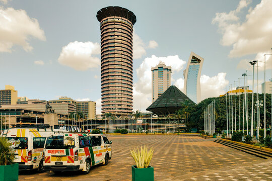 The Kenyatta International Convention Centre KICC Tower and Amphitheater with Matatus in the Plaza, Nairobi, Kenya