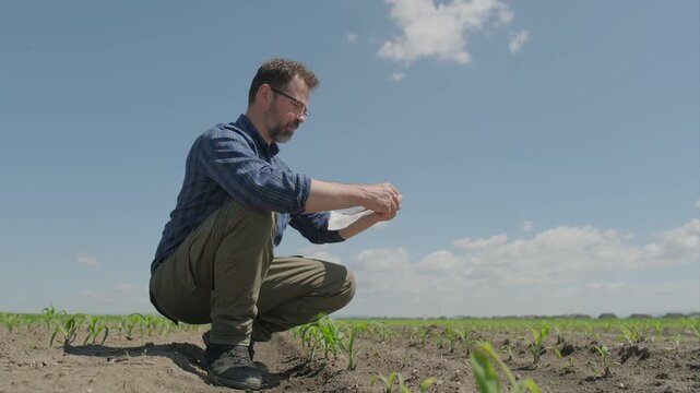 Agronomist collecting soil sample in plastic bag, Part 2