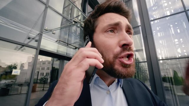 Angry middle aged Caucasian businessman yelling mobile phone outdoor city office screaming during call argument quarrel work stress fury male business man shouting cellphone conflict corporate problem