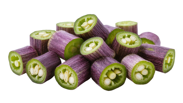 Isolated pile of fresh sliced purple garlic scapes revealing green cross sections and inner core