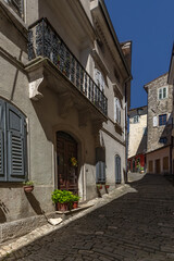 Obraz premium A walk through the narrow streets of Motovun in Croatia, high stone walls, lush Mediterranean vegetation, eat dishes with truffles, colorful walls,