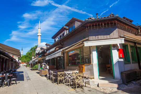 Scenic street view of the historic Bascarsija old bazaar with traditional shops and Gazi Husrev Beg Mosque in Sarajevo, Bosnia and Herzegovina
