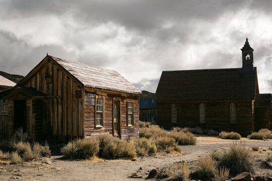 Historic wooden buildings under storm clouds in a western ghost town