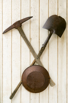 Vintage mining tools hanging on a wooden wall