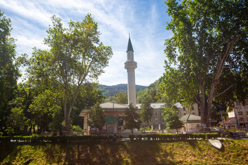 Obraz premium Sarajevo, Bosnia and Herzegovina, May 30, 2026, Historic Ottoman Bakr Baba Mosque surrounded by lush green trees and park