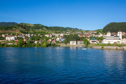 Bosnia and Herzegovina, May 30, 2026, Panoramic riverfront view of Visegrad old town and the Church of Emperor Lazar in Andricgrad along the Drina River