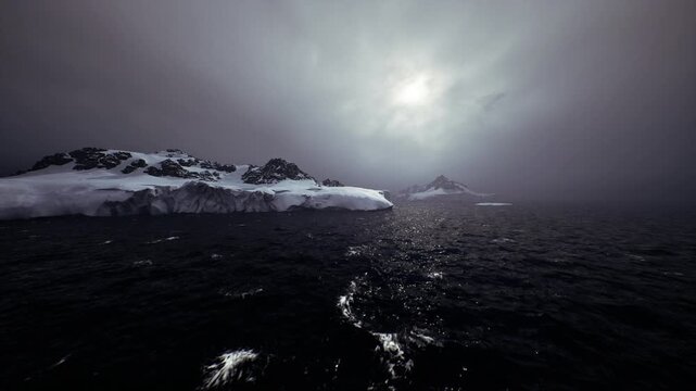 iceberg drifting on choppy dark sea, low sun piercing through heavy clouds, glittering water reflections, spray and swell against distant ice, brooding