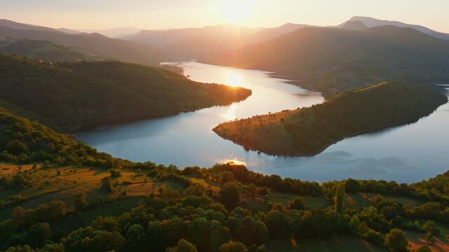 Kardzhali reservoir bend canyon landscape sunset golden hour light over hills green mountains valley water reflection panoramic aerial drone view travel Bulgaria
