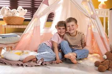 Little girl and boy near wigwam at home © New Africa
