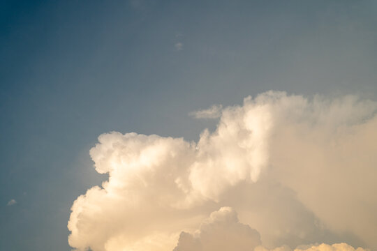 Dramatic white clouds against a deep blue sky, evoking peaceful contemplation.