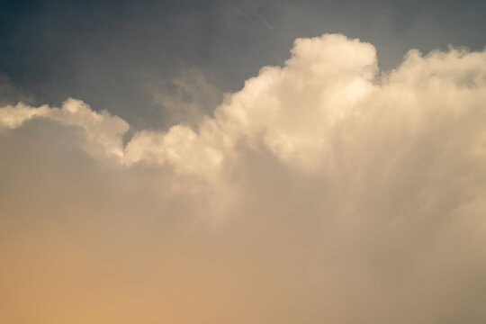 Soft white clouds against a gradient sky at sunset.