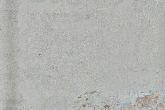 Textured gray wall with subtle peeling and stains.