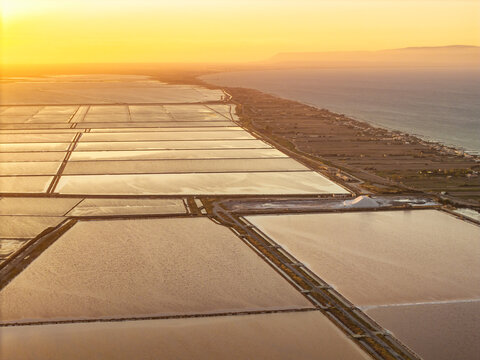 Aerial view of the Margherita di Savoia salt mines at sunset in Puglia, Italy