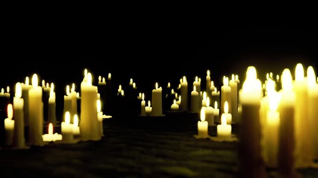 Dim luminous shelter. Emergency illumination from scattered candle flames. Room filled with scattered candles offering gentle light during power failure