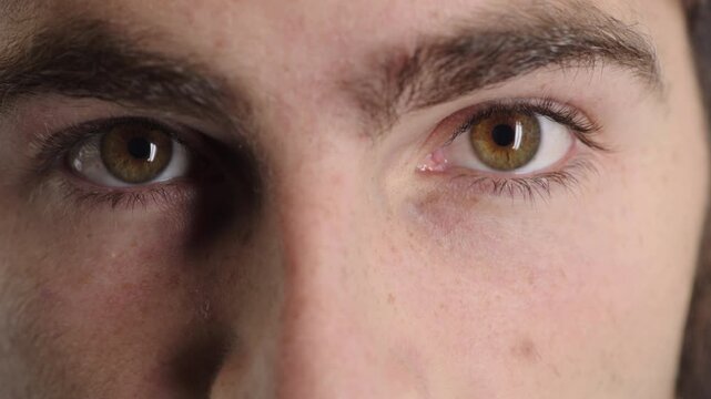 Man, face and stare with eyes for awareness, perception or eyesight for emotion or psychology. Closeup, male person or frown with facial expression for observation, mood change or bipolar disorder