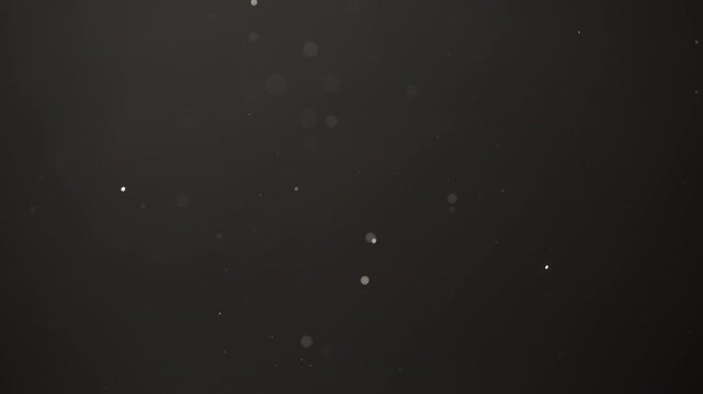 Slow motion real dust flow over dark background