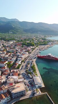 Thasos Town Waterfront with Red Ferry and Mountain Background