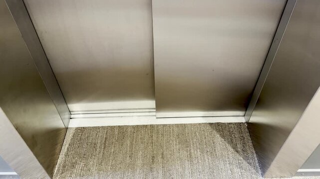 Opening Steel Elevator Door from Hallway to Empty Inside View