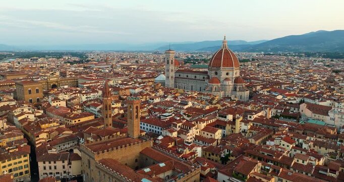 Florence Duomo dome golden hour aerial Tuscany Italy terracotta rooftops warm sunset light drone shot Renaissance architecture travel landmark Firenze cityscape slow motion overview