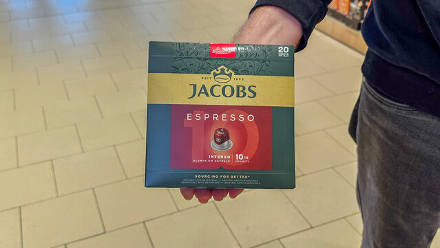 Hand holding jacobs espresso intenso coffee capsules in a supermarket