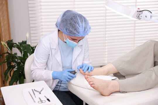 Woman undergoing toenail treatment during visit to podiatrist in clinic, closeup