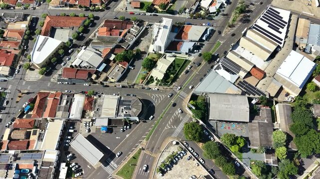 Aerial view of an urban intersection with buildings, roads, and vehicles.