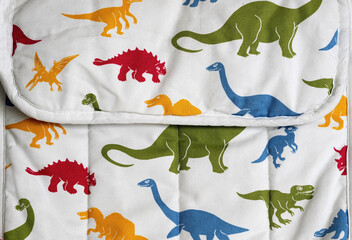 Colourful Dinosaur Pattern on Wrinkled Fabric Background © Goran