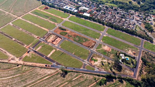 Aerial view of a new housing development under construction with roads and cleared land for homes