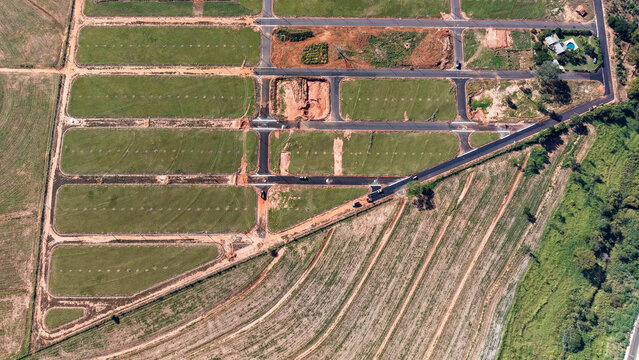 Aerial view of a new housing development under construction with cleared land and roads