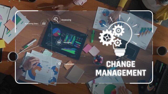 Aerial view of a collaborative team engaged in change management strategies. This modern office scene captures brainstorming, data analysis, and innovative discussions for effective planning. Raster