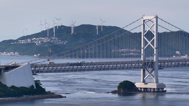 大鳴門橋の車流と遠くの風車を望む静止空撮映像