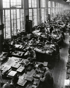 1890s Black and White Industrial Workspace: Historical Printing Press Factory with Workmen Engaging in Manual Labor and Mass Production